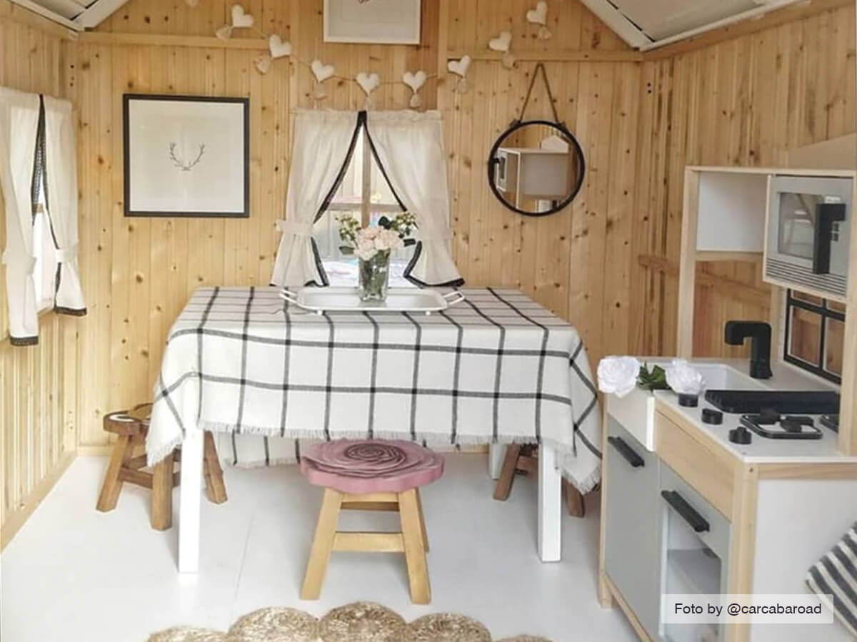 Inside view of Kids Playhouse Arctic Nario with furniture and kids kitchen set |white Outdoor Playhouse by WholeWoodPlayhouses 