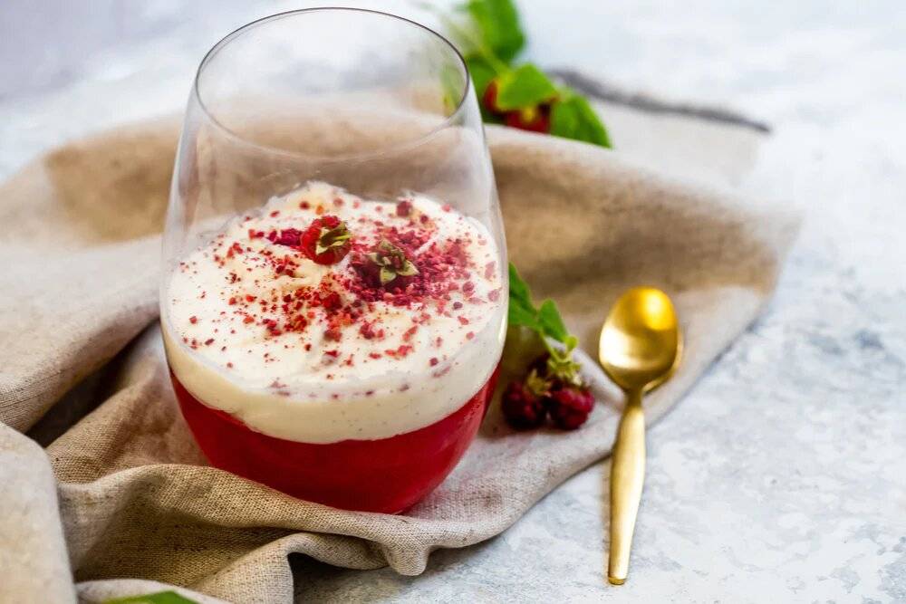 Raspberry and prosecco jelly in a cup topped with mascarpone cream.