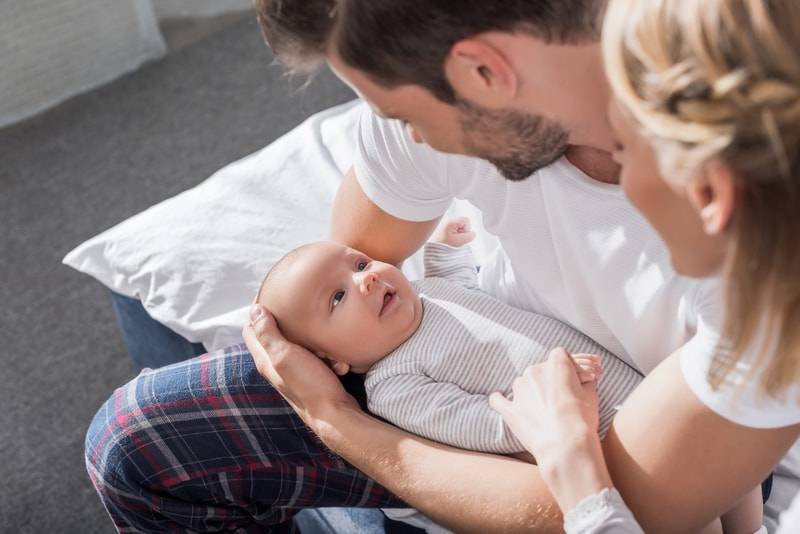 Parents playing with newborn