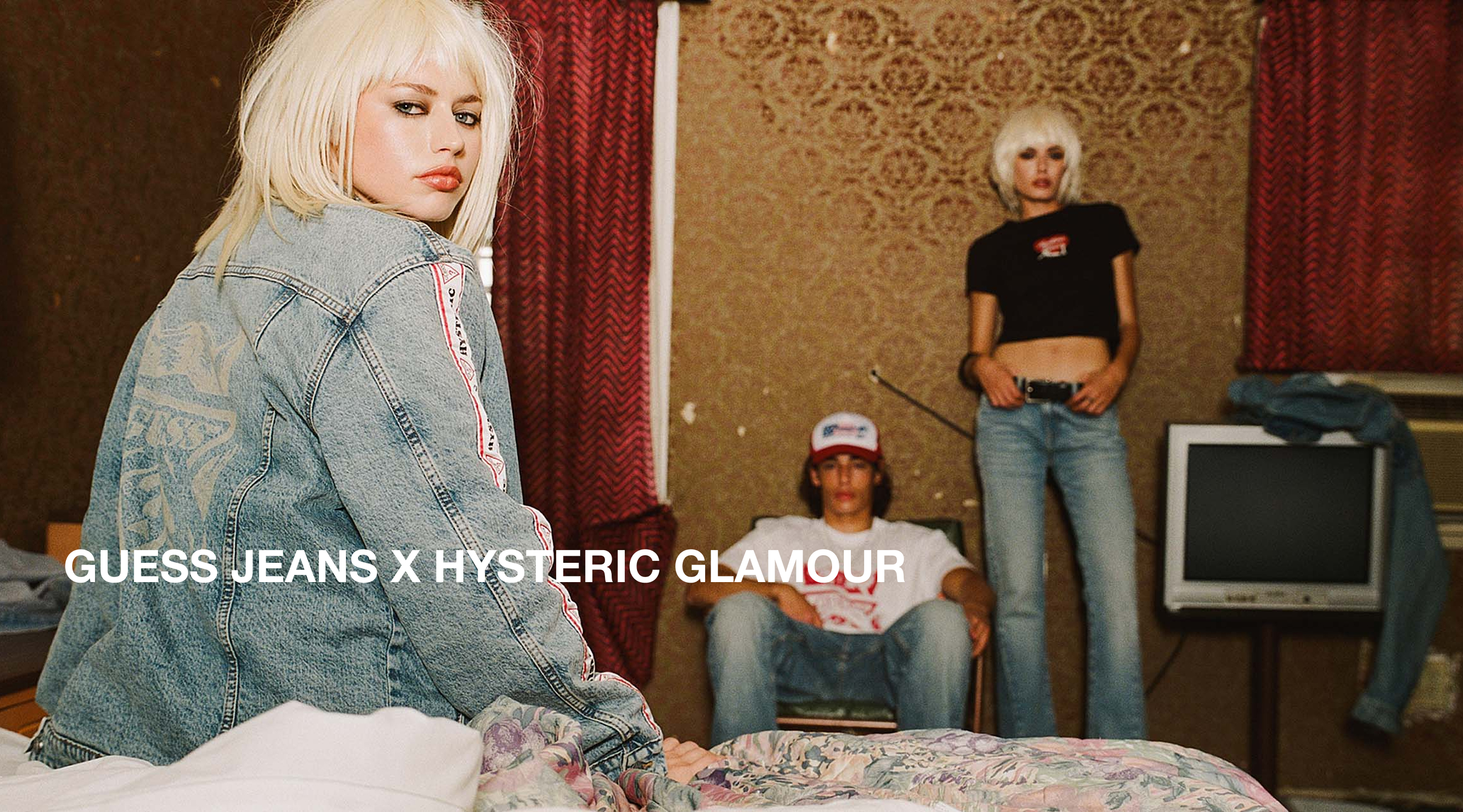 Three people posing in a room, wearing Hysteric Glamour x GUESS JEANS with a retro vibe.