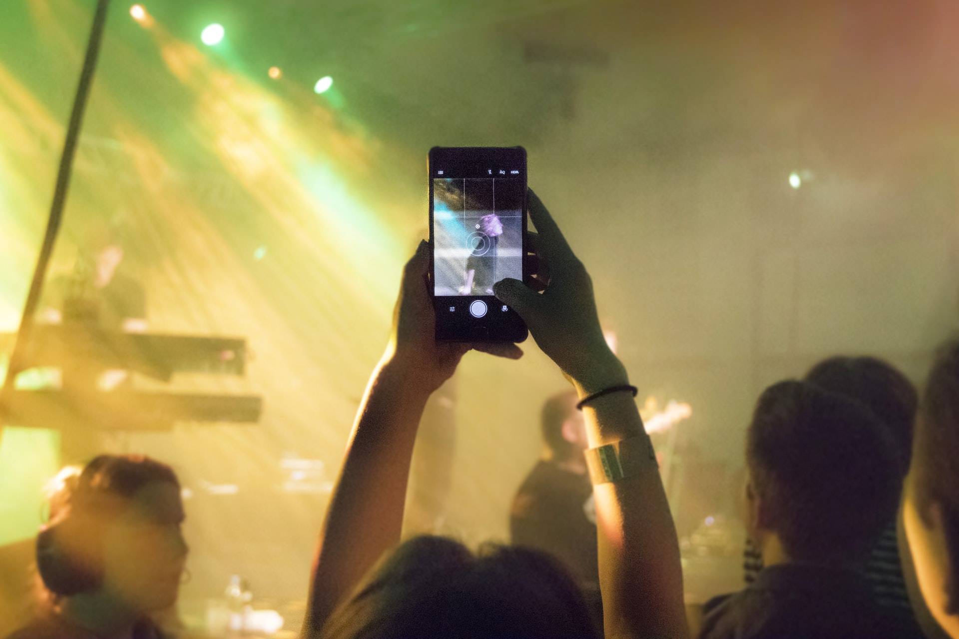 Person taking a picture at a music festival