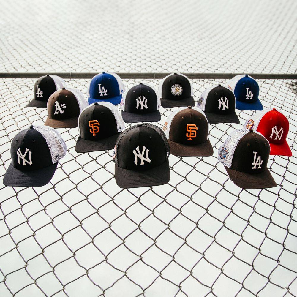 sp x '47 brand trucker hats hung on fence