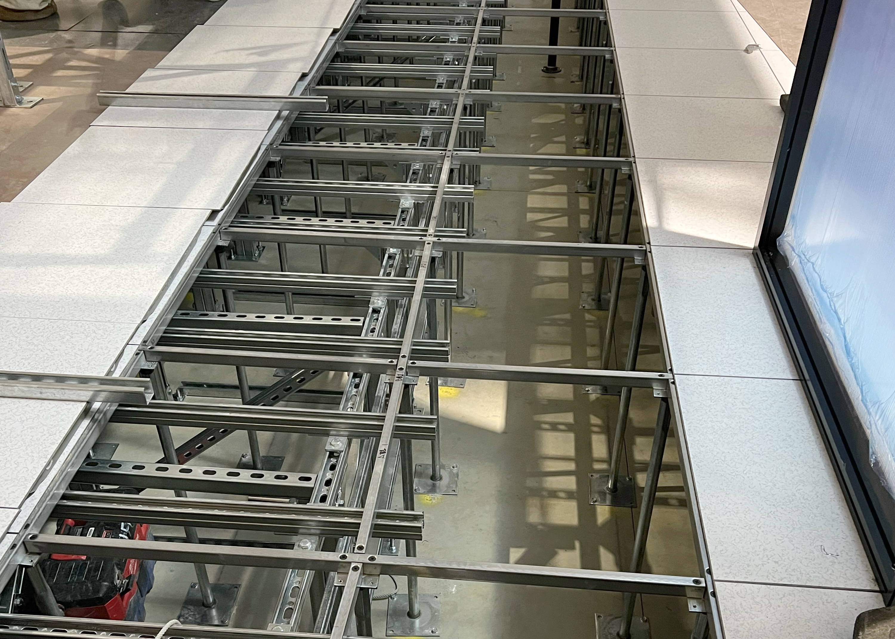 Tate Access Floor installation featuring Unistrut channel to support the heavier loads of a Data Center server(s).