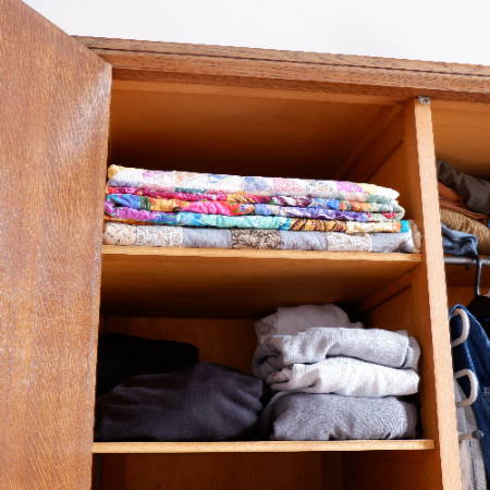 Quilts stacked in a closet