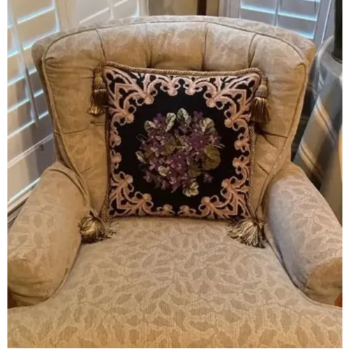 Needlepoint pillow in chair