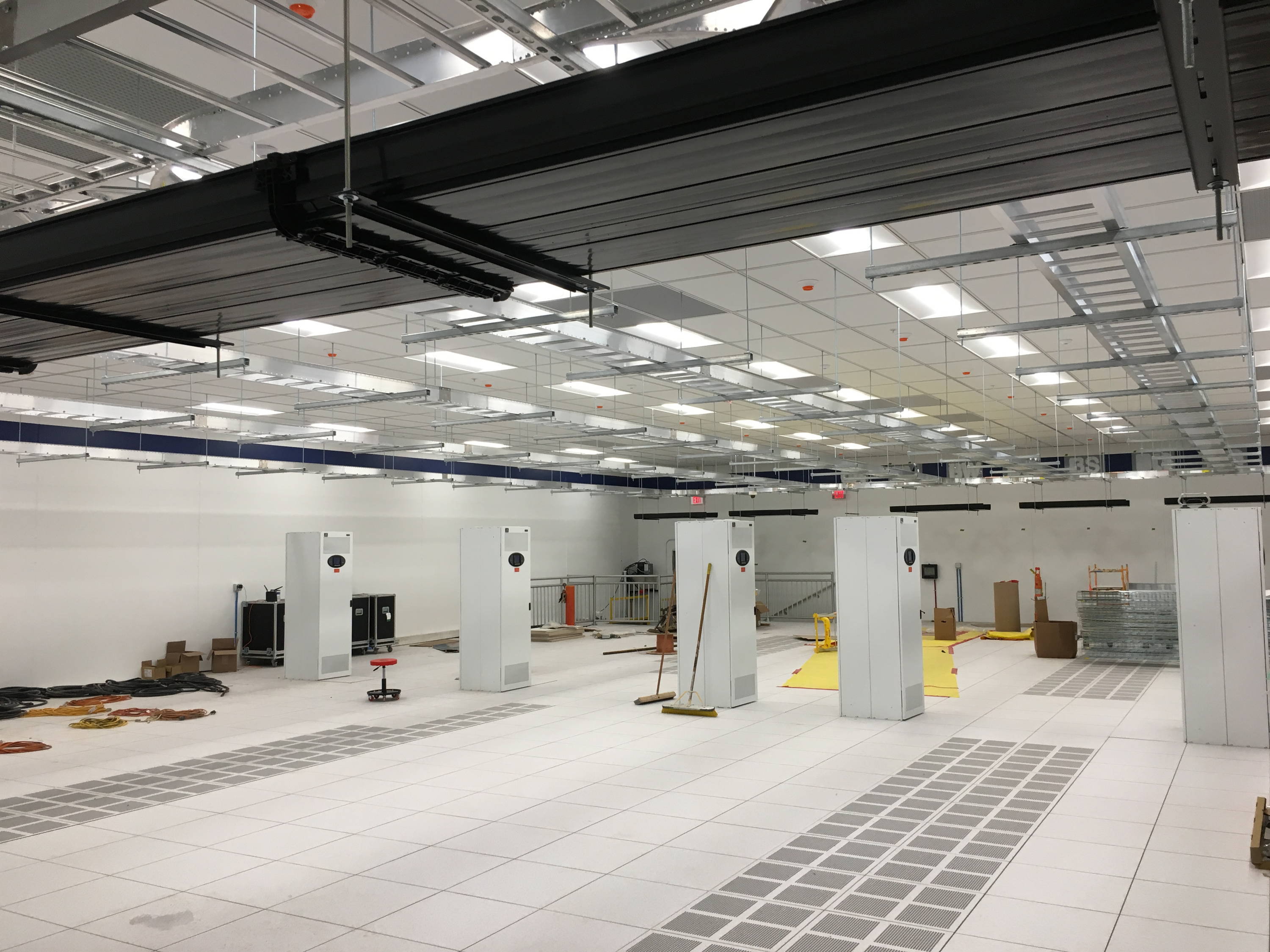Tate access floors contribute to airflow within hot aisle containment systems and facilitate the separation of cold supply air from hot exhaust air through the use of perforated panels