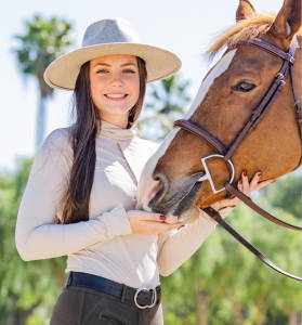 Equestrian standing with her chestnut horse wearing a Solid Citizen sunshirt. Shop all sun shirts at TriedEq.