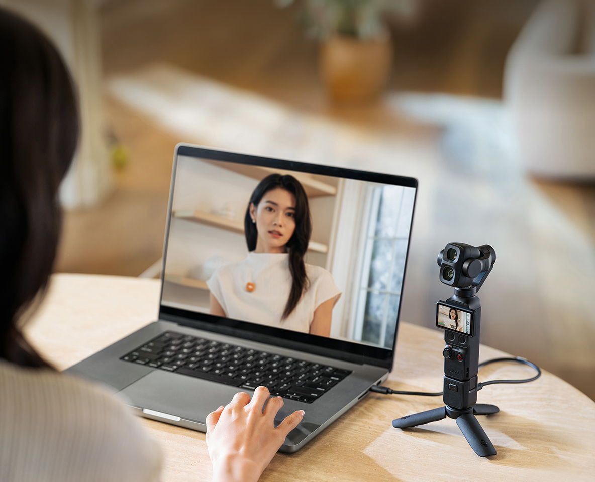 Person using a laptop to video chat, with an Osmo Pocket 4P streaming video