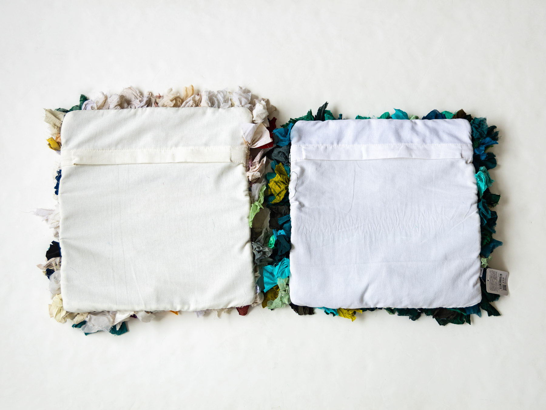 Two fabric squares with colorful edges and plain centers.