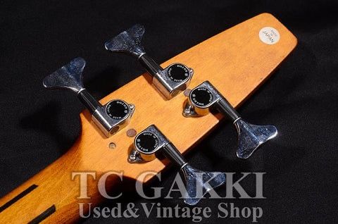 Close-up of a guitar headstock with tuning pegs.
