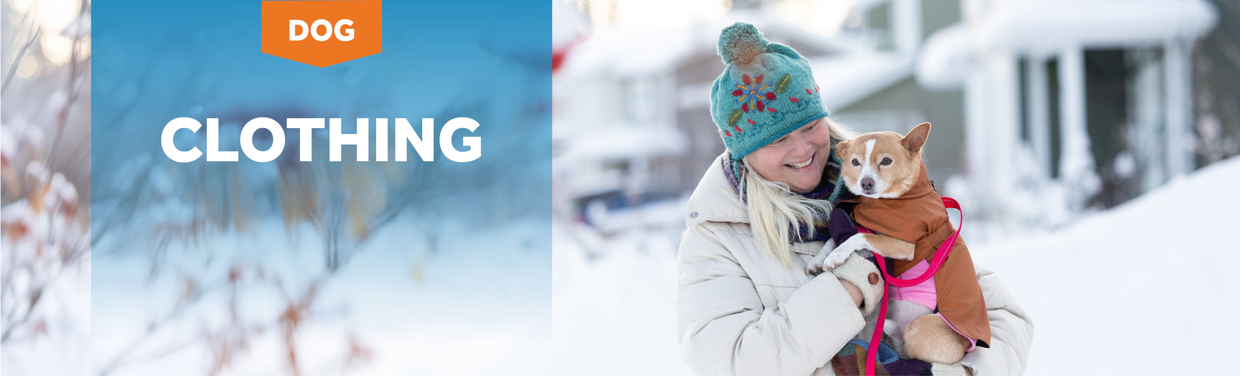 Woman in winter clothing holding a small dog in snowy surroundings.