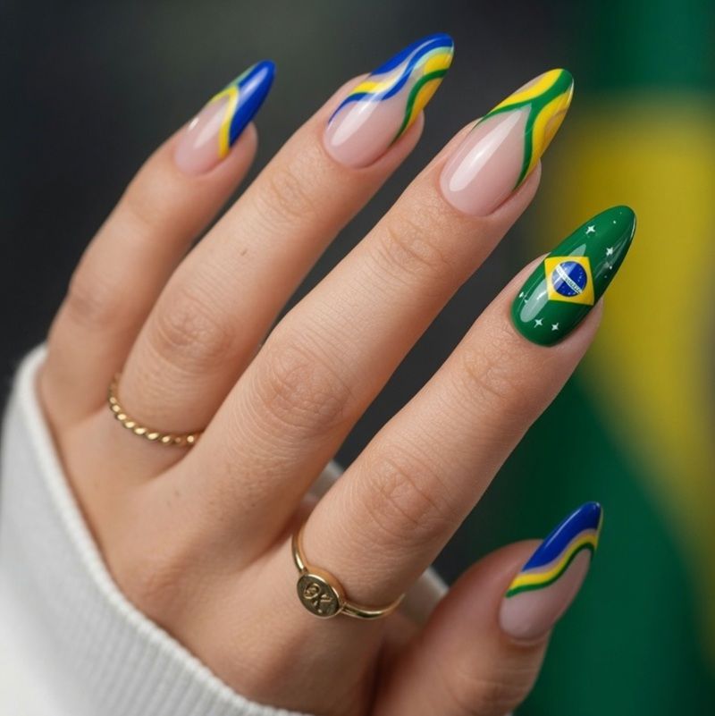Colorful nail art featuring Brazilian flag design on long nails.