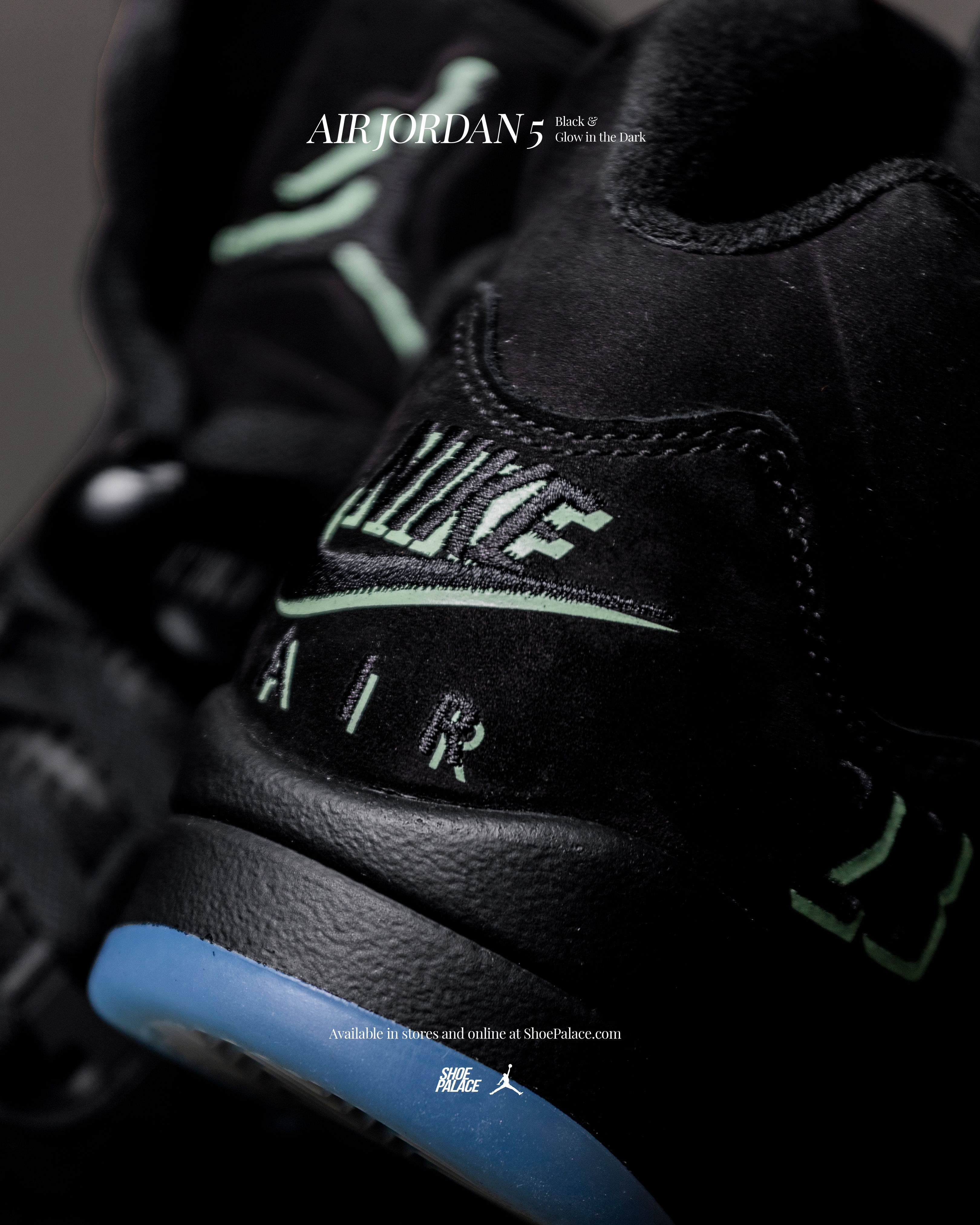 Close-up of black Nike Air Jordan 5 sneakers with glow-in-the-dark accents.