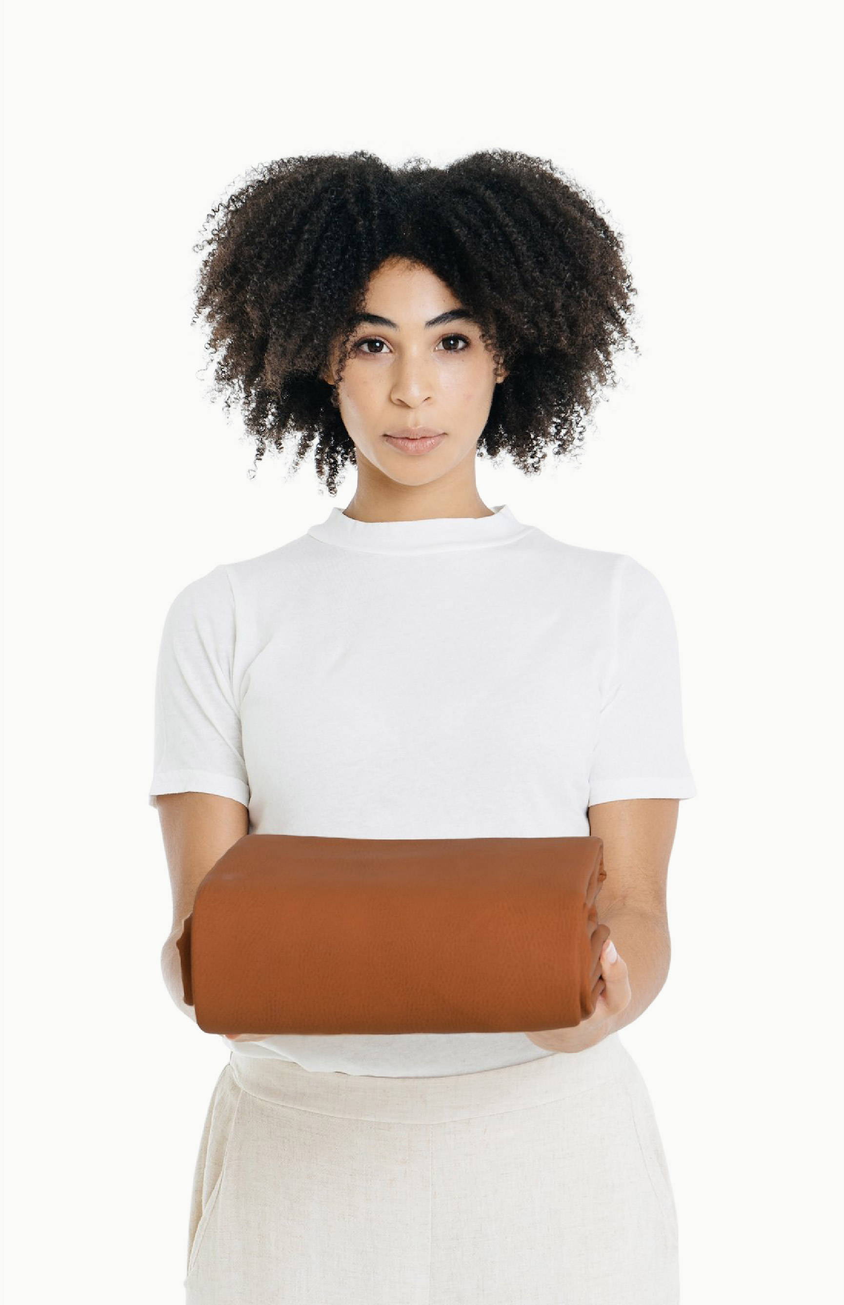women holding folded ginger leather mat