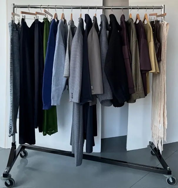 A clothing rack displaying various garments in different colors.