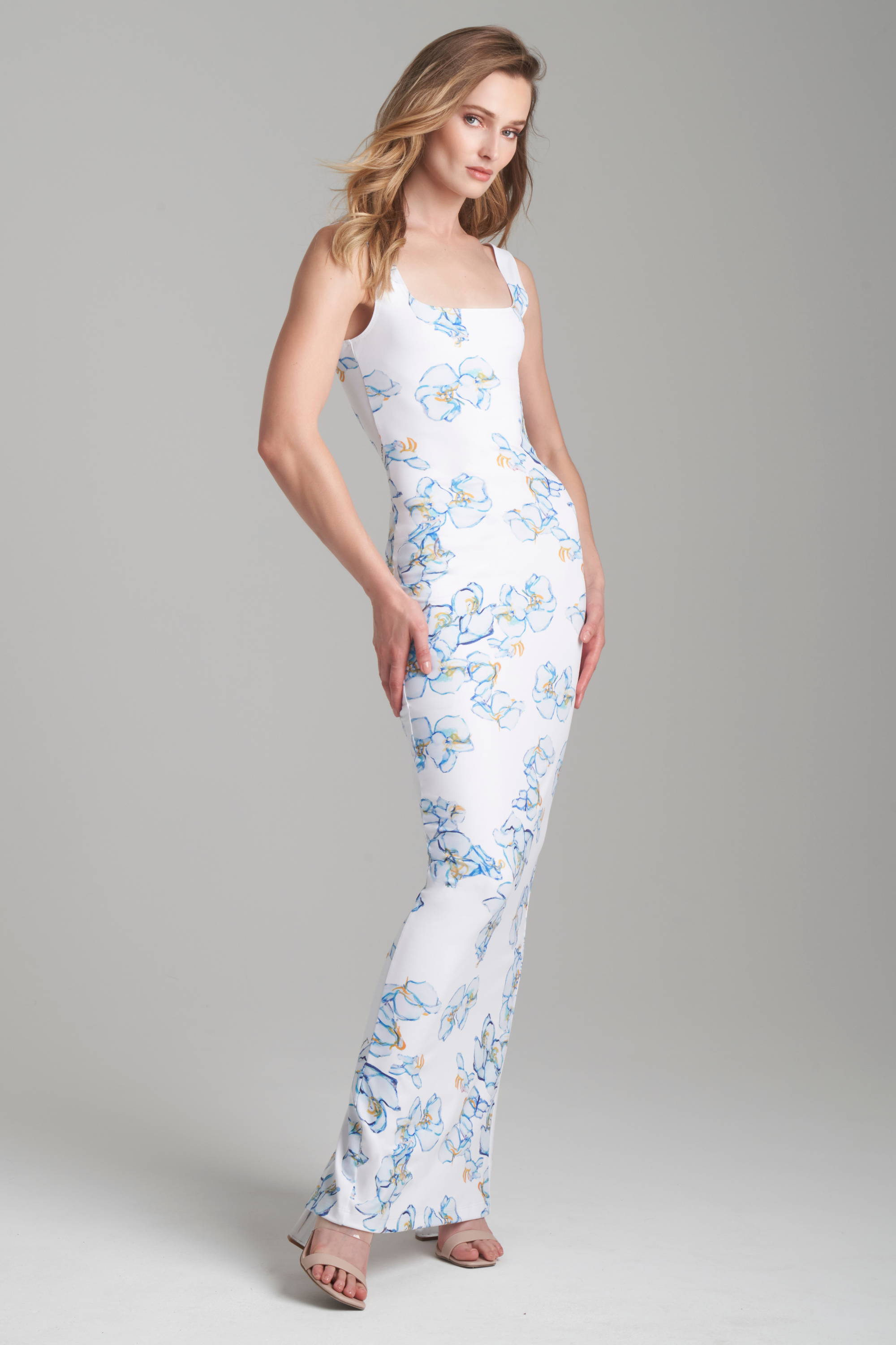 Woman wearing long orchid printed white and blue stretch knit dress by Ala von Auersperg for spring 2024