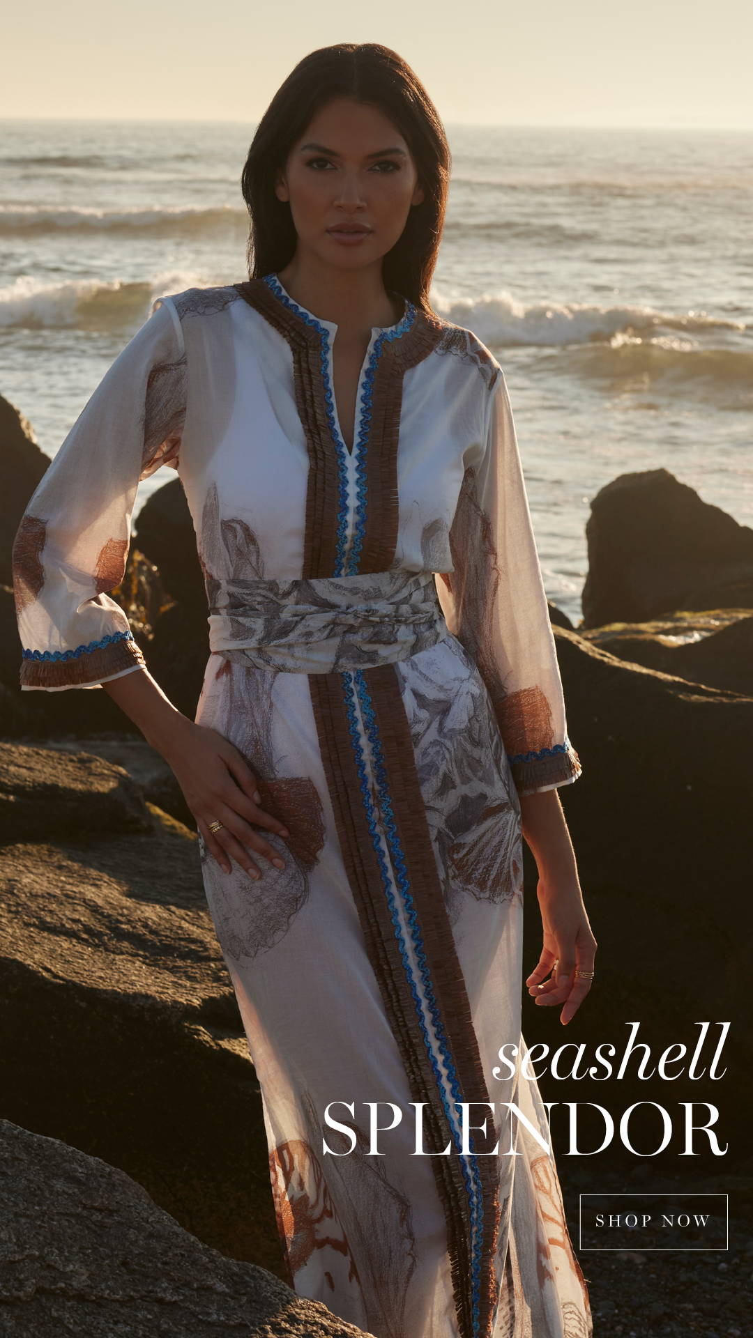seashell splendor | woman wearing shell printed white and brown cotton kaftan with belt by the ocean by Ala von Auersperg for resort 2024