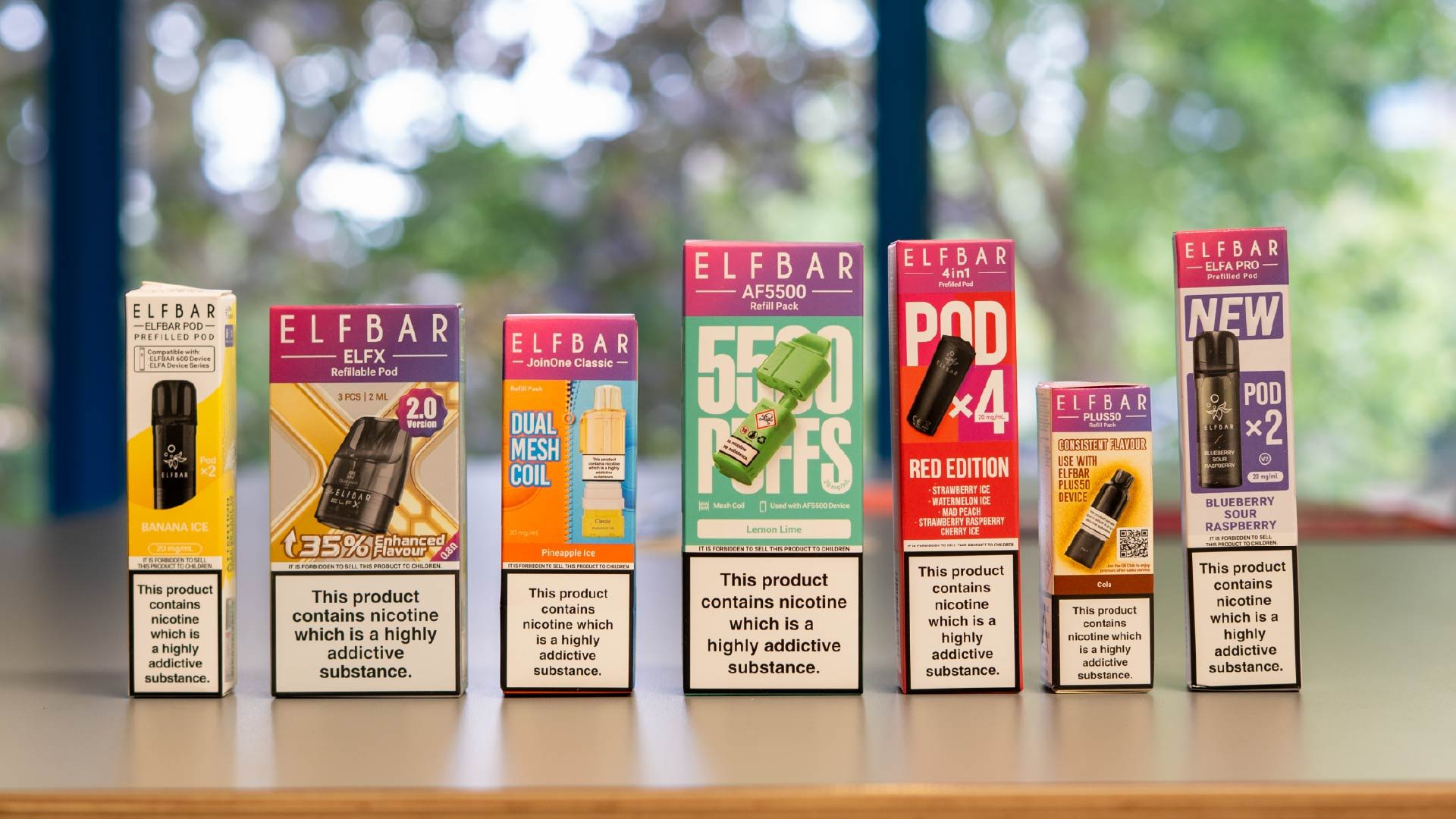 A selection of elf bar pods lined up on a table.