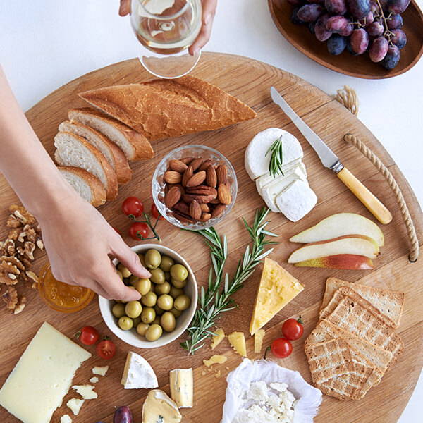 High Quality Organics Express Cheese board with olives and bread and almonds