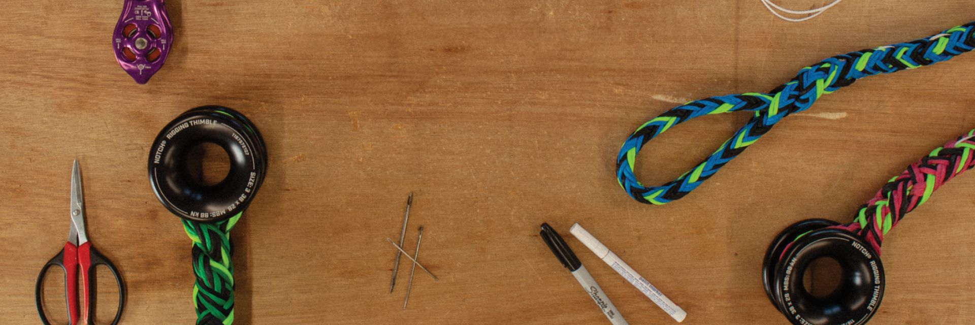Tools and materials arranged on a wooden surface for crafting or repair.