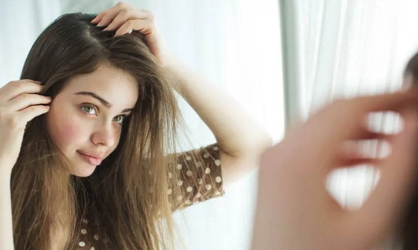 Brown haired girl checking her hair
