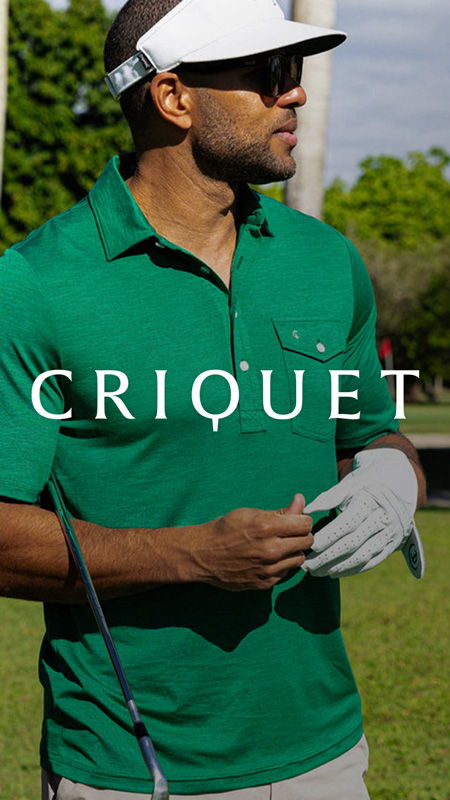 Man in green polo shirt, preparing to play golf outdoors.