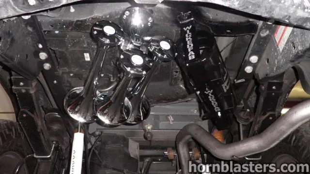 Four chrome train horns and WICKEDFAB air tank installed on the undercarriage of Wicked Customs's Ford F250