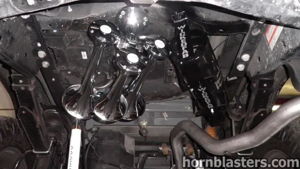 Four chrome train horns and WICKEDFAB air tank installed on the undercarriage of Wicked Customs's Ford F250