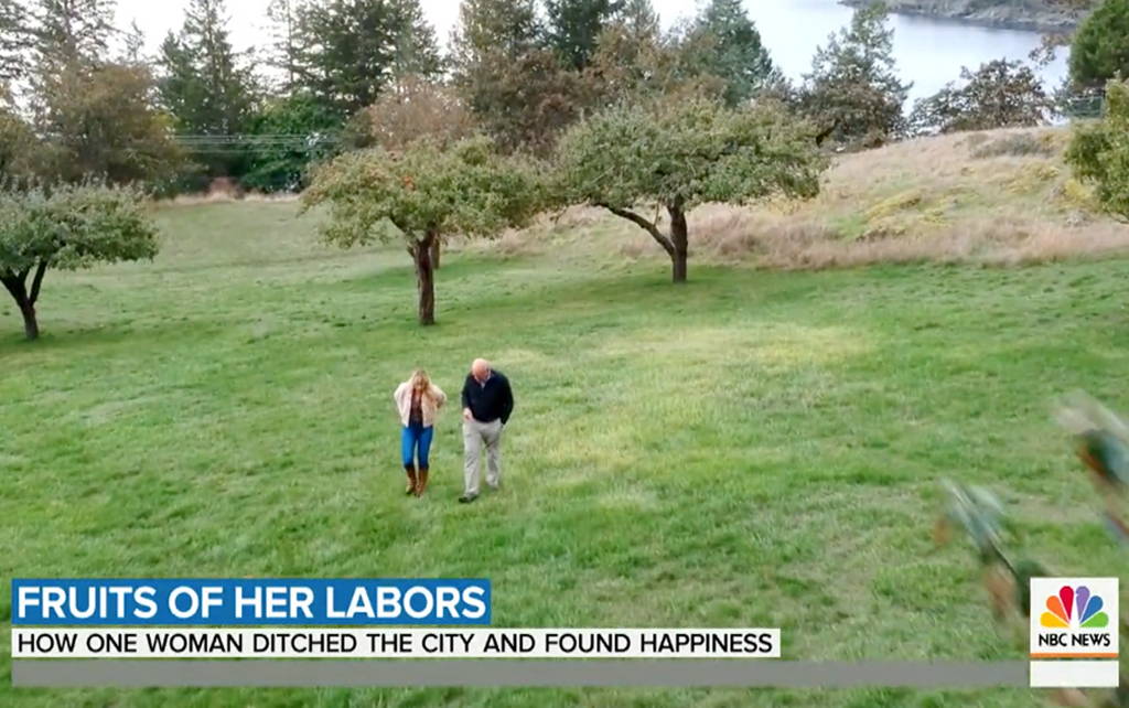 Audra Lawlor, founder & president of Girl Meets Dirt walks through orchard with Harry Smith during filming of The Today Show.