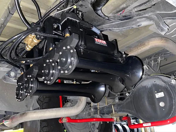 Rear-right close-up horn bracket mounting frame rear differential exhaust pipe Rudy's Toyota Tundra Conductor's Special 244K gallery photo 3