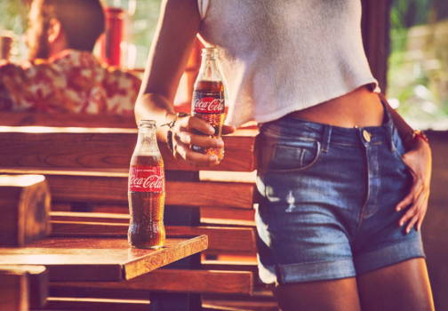 Girl enjoying Mexican Coke on a hot day