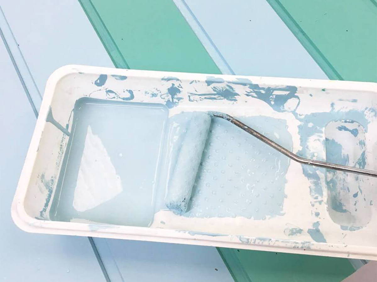 Paint tray with blue paint and paint roller by WholeWoodPlayhouses
