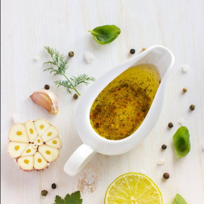 infused olive oil surrounded by garlic and herbs