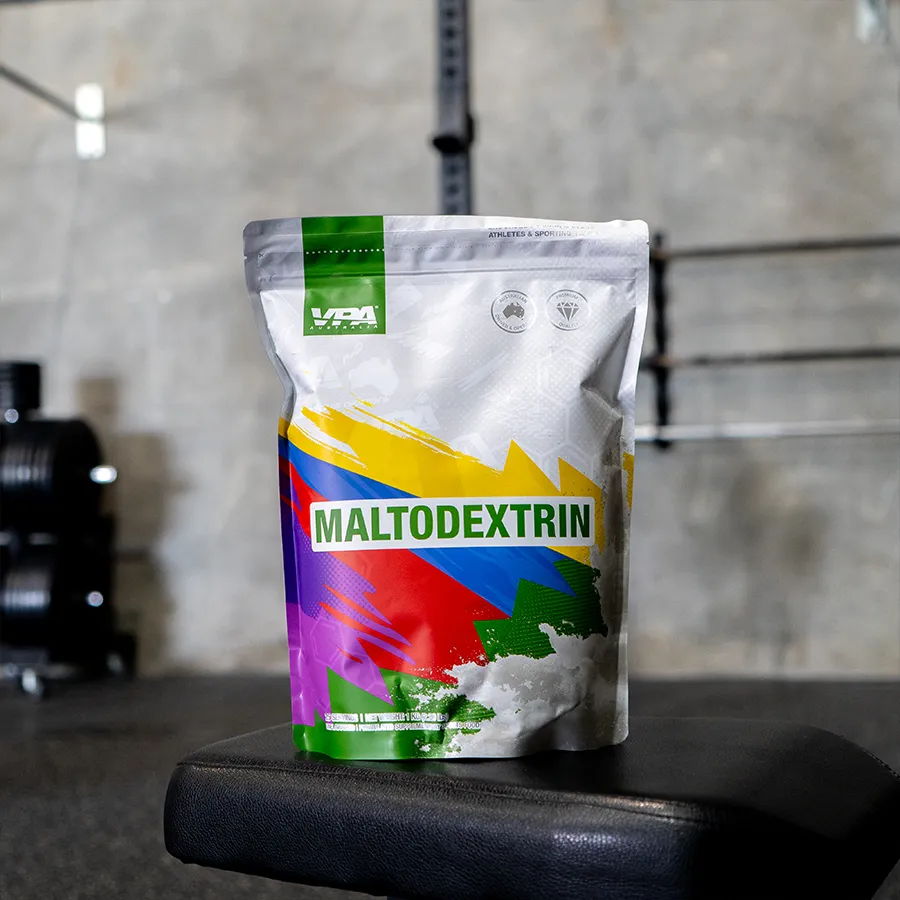 Package of maltodextrin on a gym bench with weights in the background.