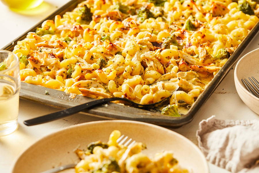 Cavatappi pasta combined with broccoli and chicken in a cheesy sauce prepared in a sheet pan