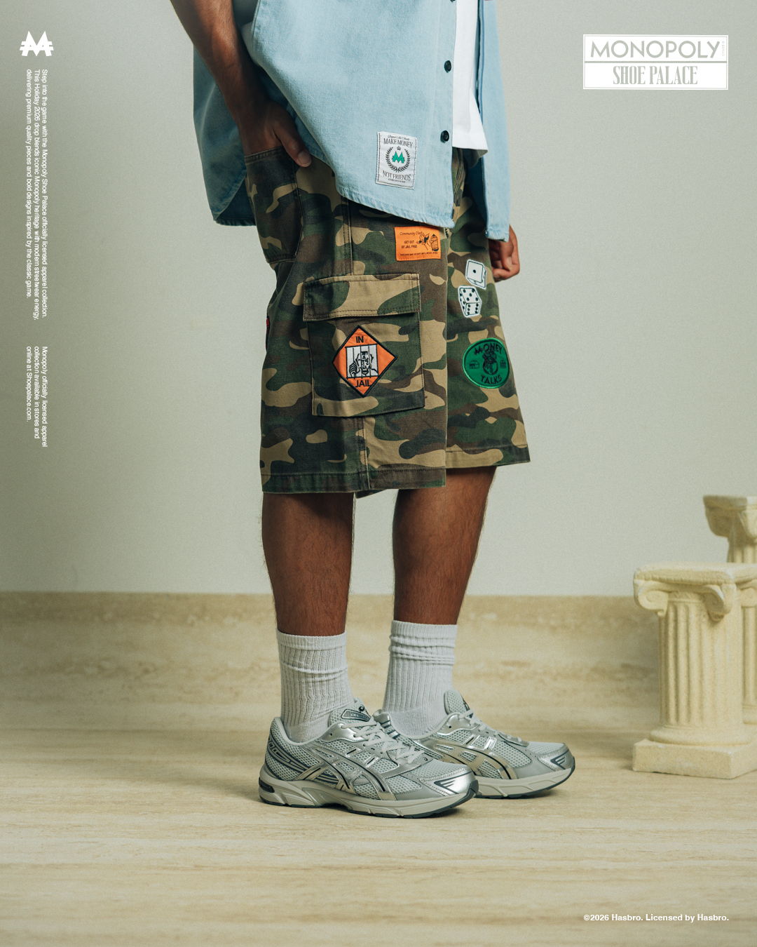 Person wearing camo shorts, a blue shirt, and silver sneakers.