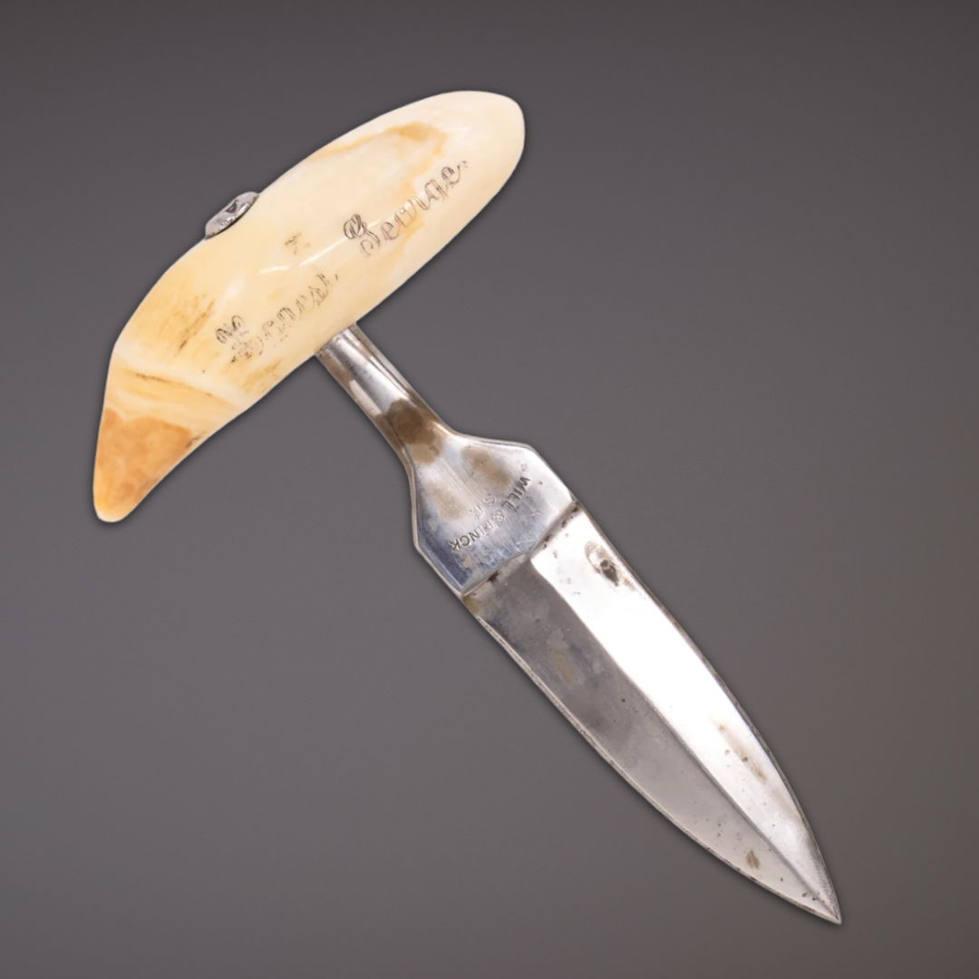 A curved knife with a decorative handle.