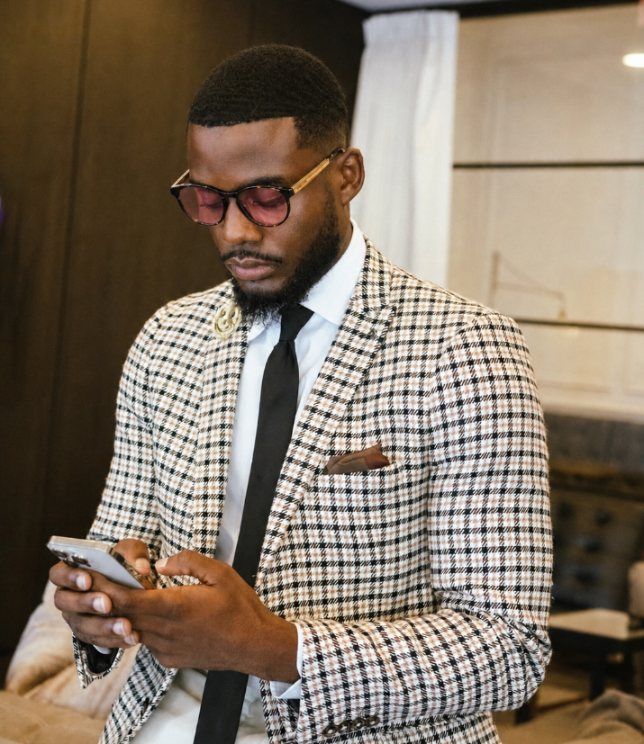 Man looking at a phone screen wearing fl41 glasses for migraine