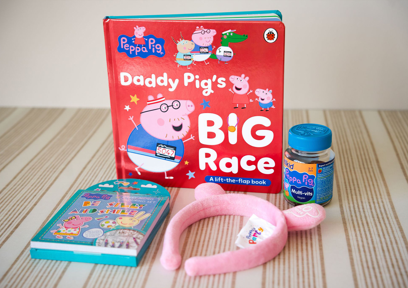 Children's book and toys featuring Daddy Pig from Peppa Pig series.