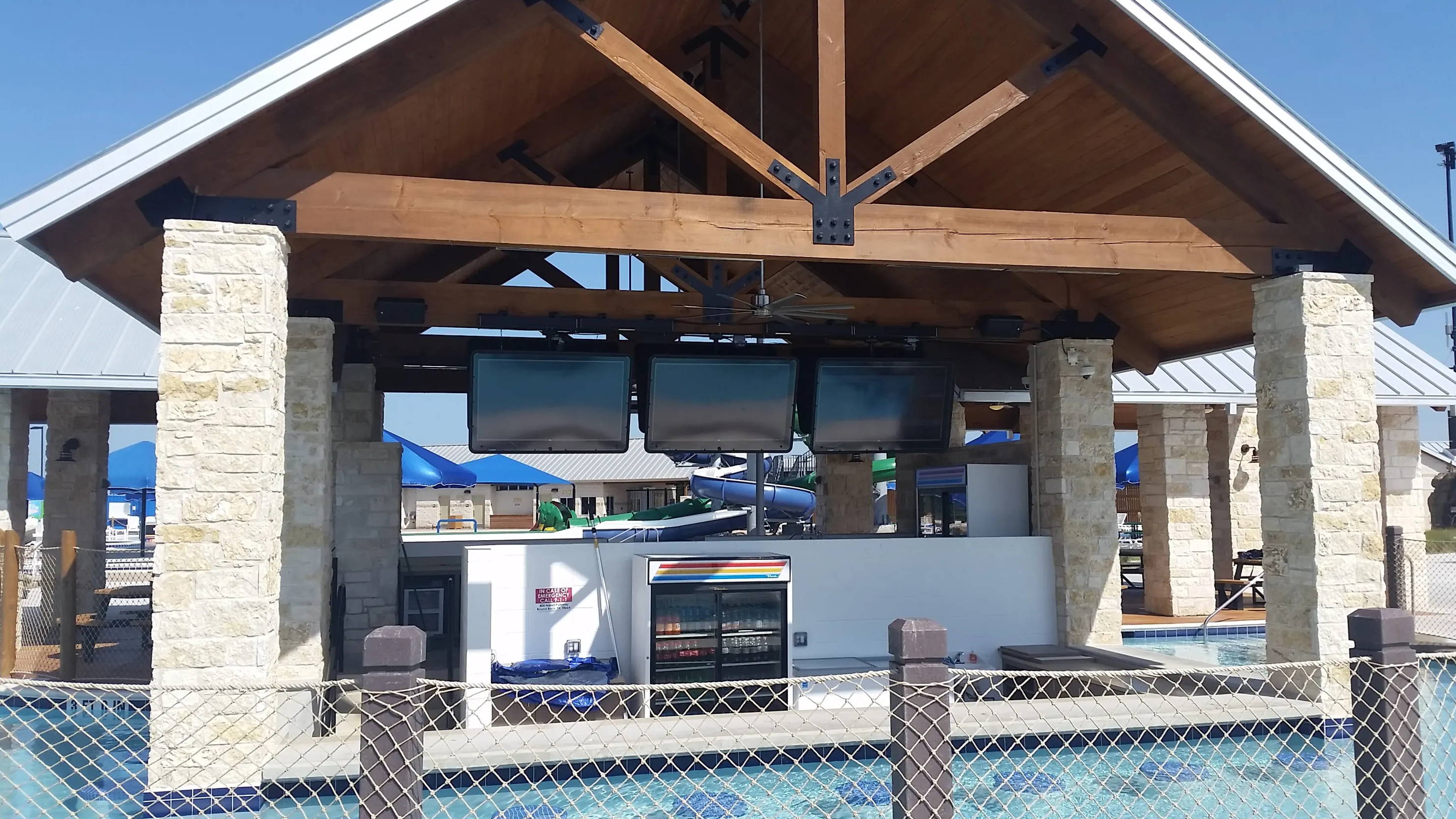 The TV Shield outdoor TV cabinets above pool at water park