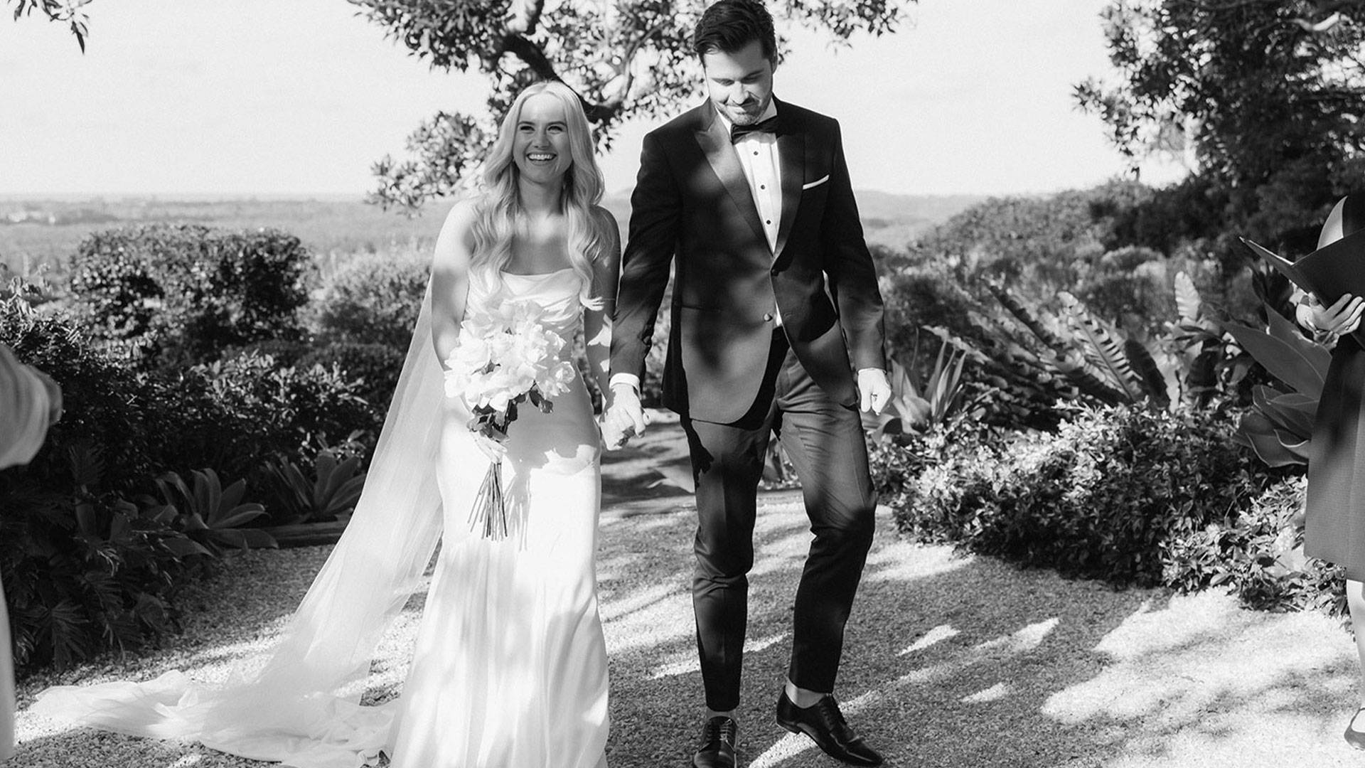 Bride and Groom holding hands walking down aisle