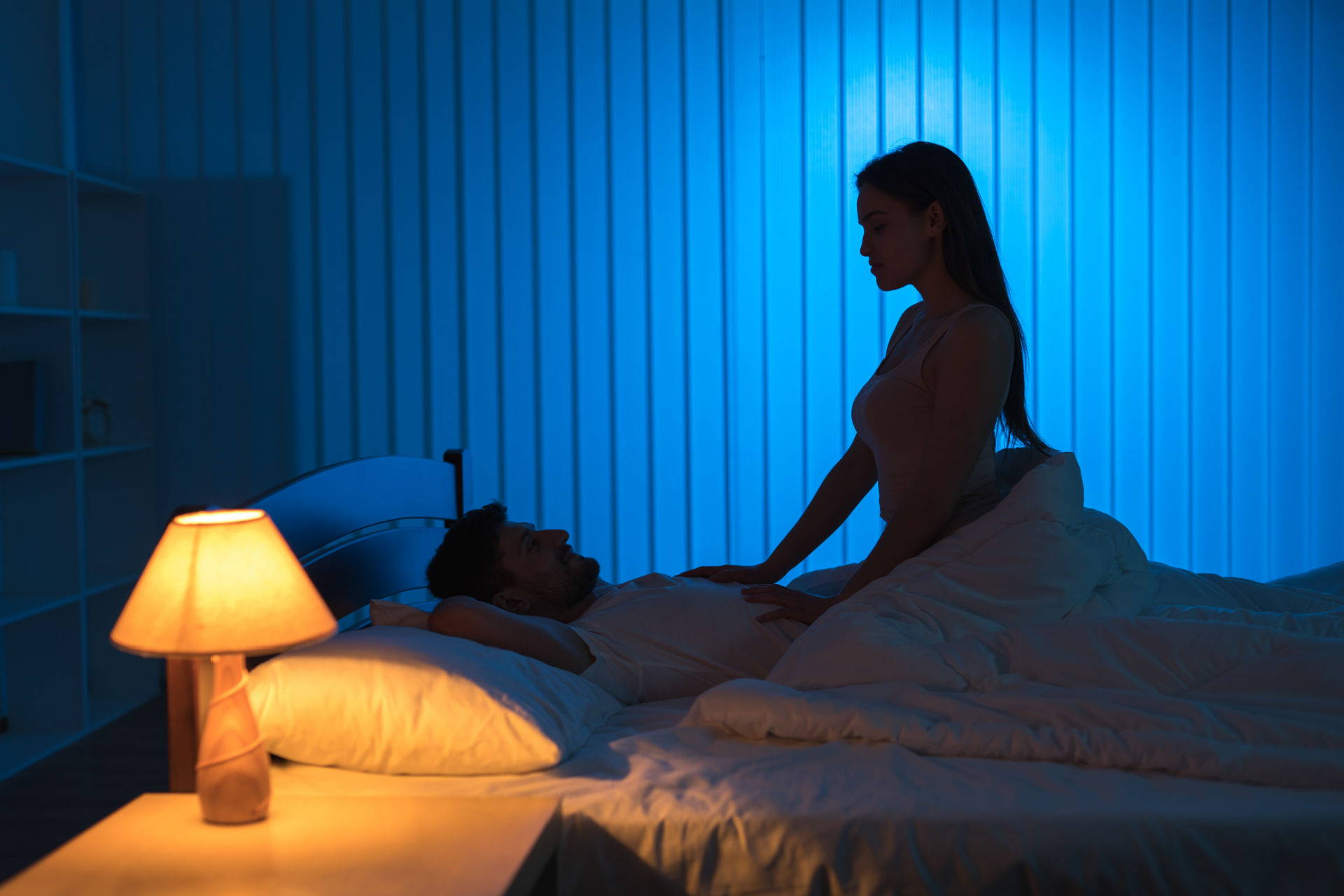 A couple in a bedroom, with the woman straddling the man on a cbd infused bed