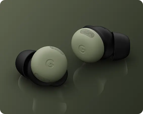 Wireless earbuds in green and black on a dark background.