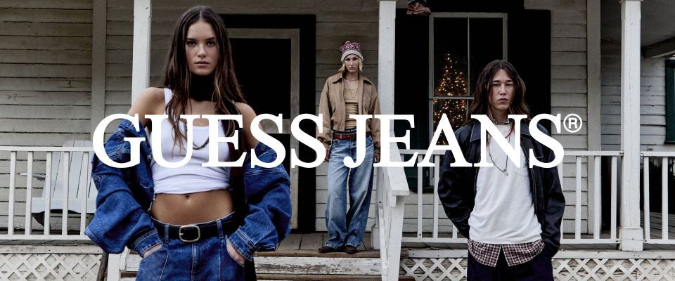 Group of people modeling Guess Jeans in a rustic setting