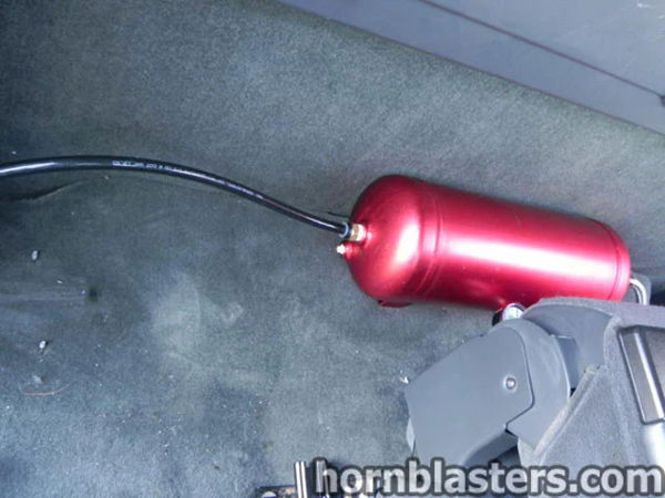 Alternate angle of the red air tank mounted inside Thomas's 2005 Chevrolet Silverado 1500 cabin, install photo 11