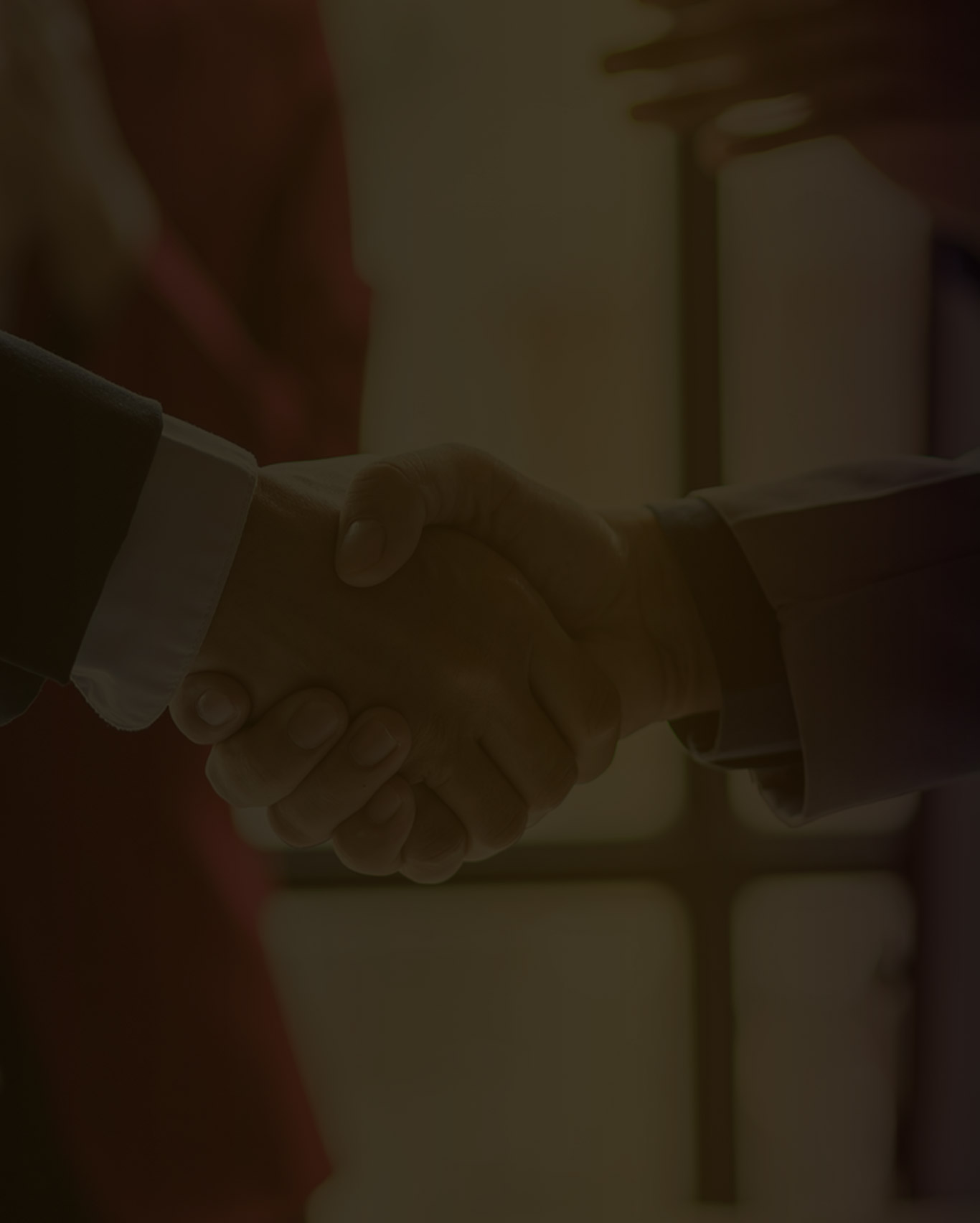 Close-up of two professionals shaking hands, representing a business partnership and collaboration