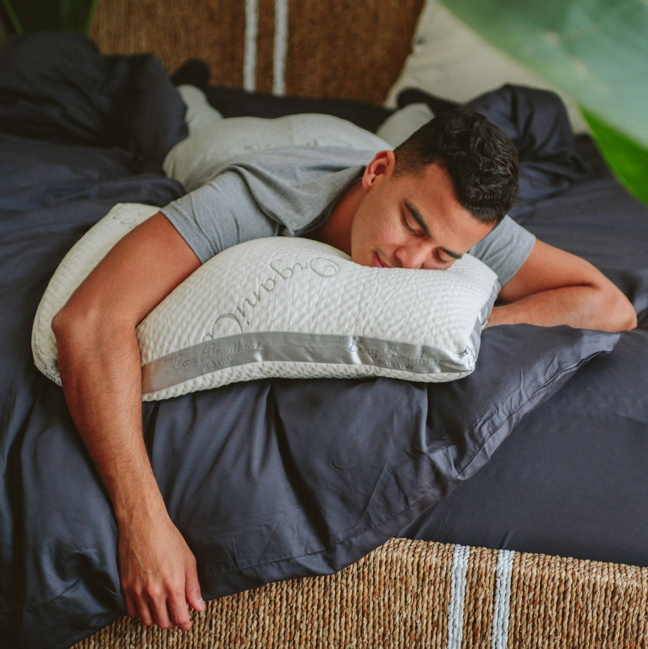 a man sleeping on easy breather natural pillow and nest bedding
