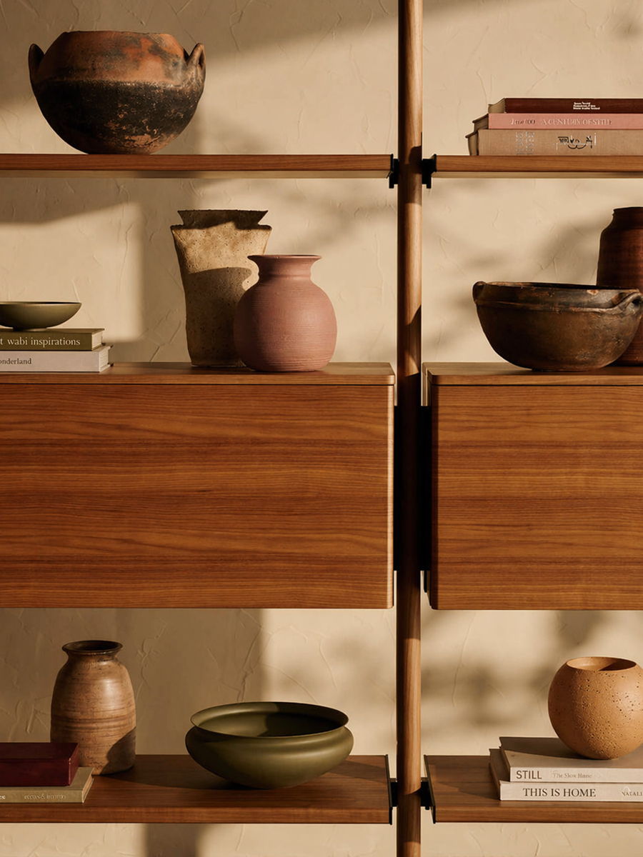 Shelving unit with various ceramic pots and books.