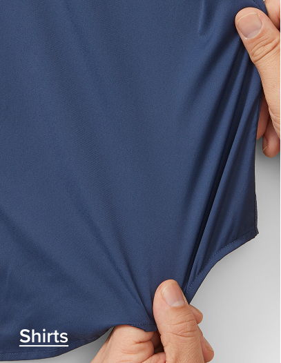 Hands holding a navy blue shirt fabric.