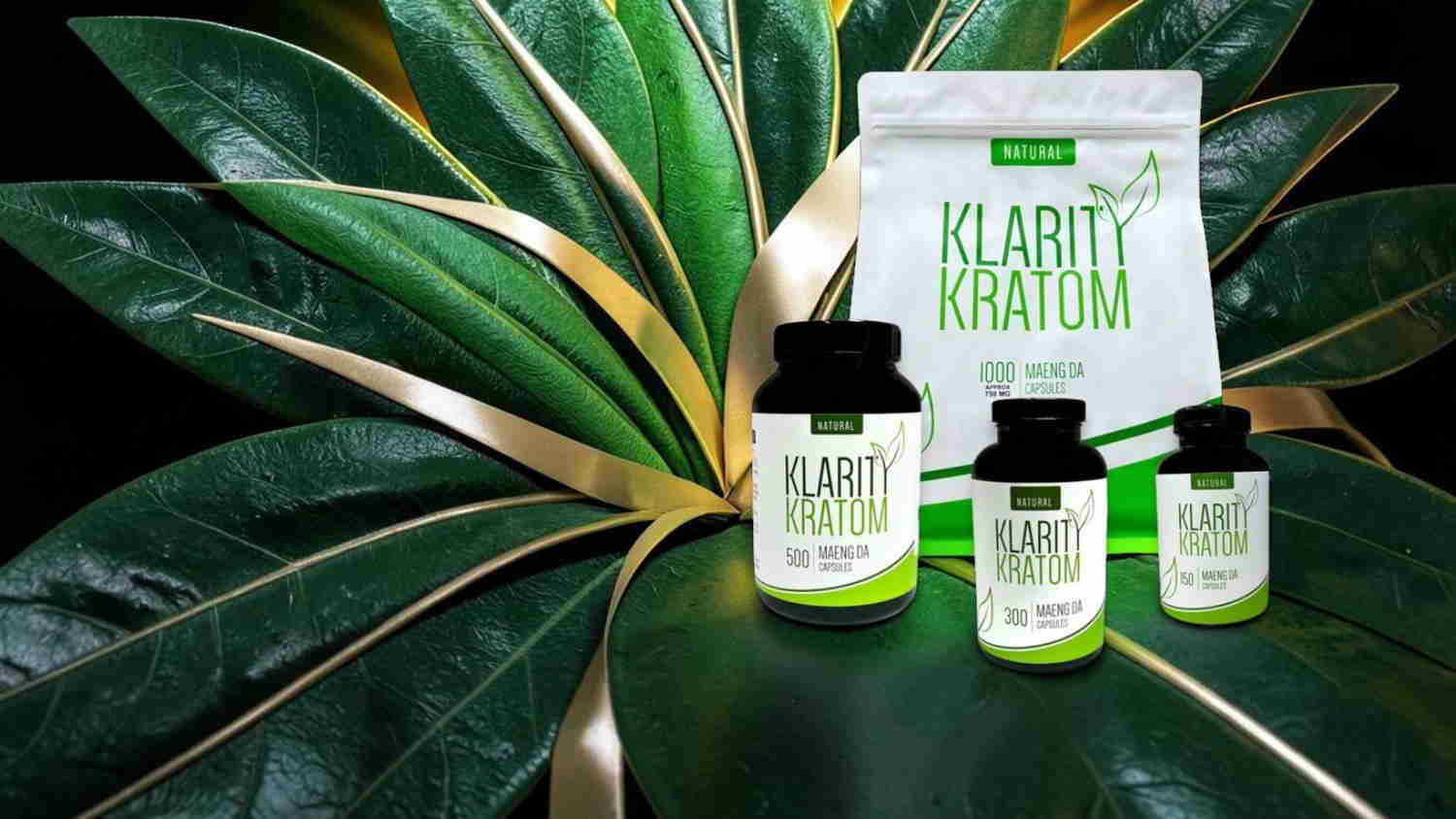 Three bottles of Kratom supplements on large green leaves.